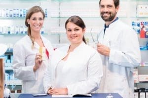 three pharmacy students smiling at camera