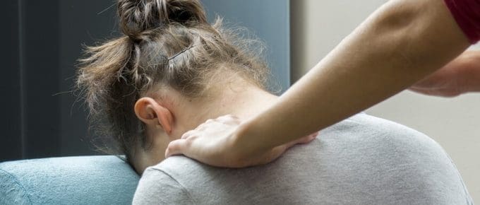 chiropractor working on female's neck