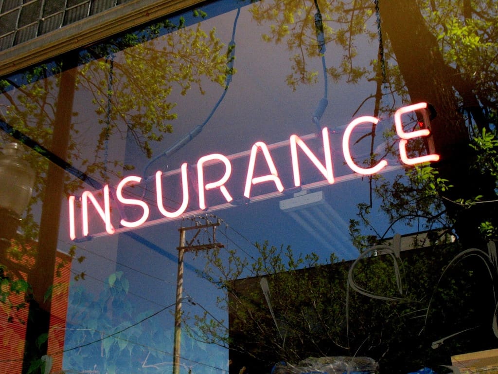 glass window of building with insurance light on