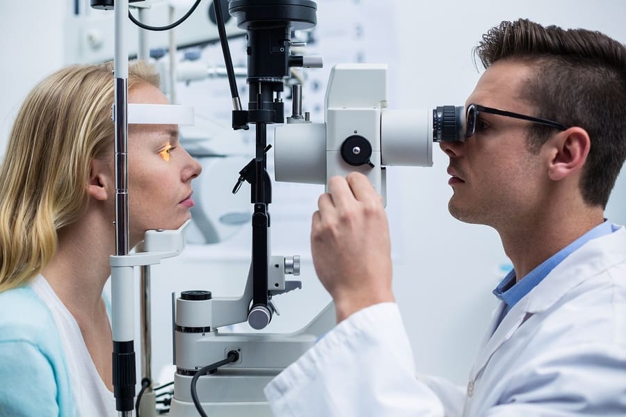 optometry student examining female student