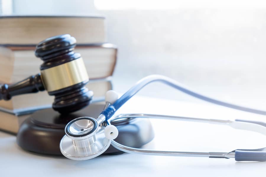 stethoscope, gavel and books on desk