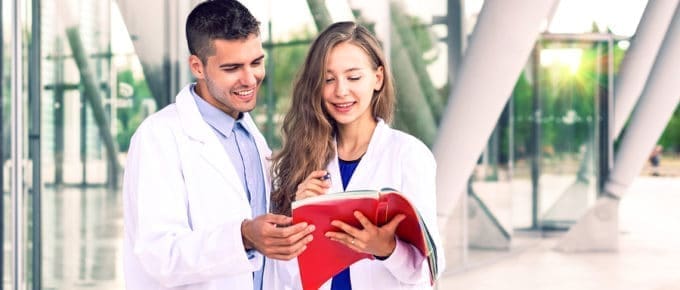 dental students looking at textbook