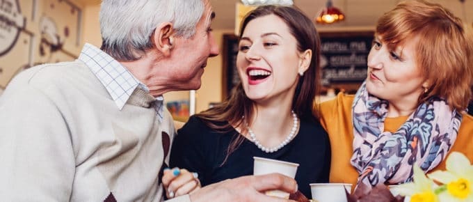 female with parents in coffee shop