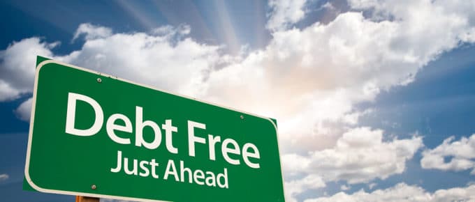 billboard in blue sky with clouds that says debt free just ahead