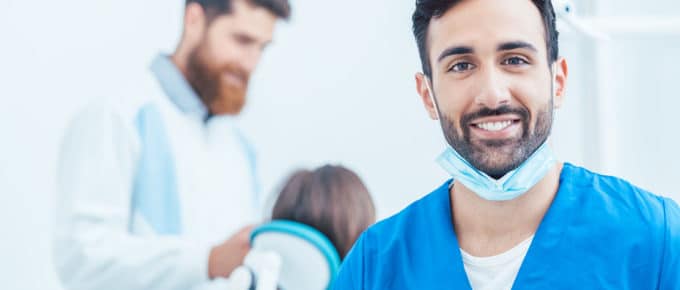 male dentist smiling at camera