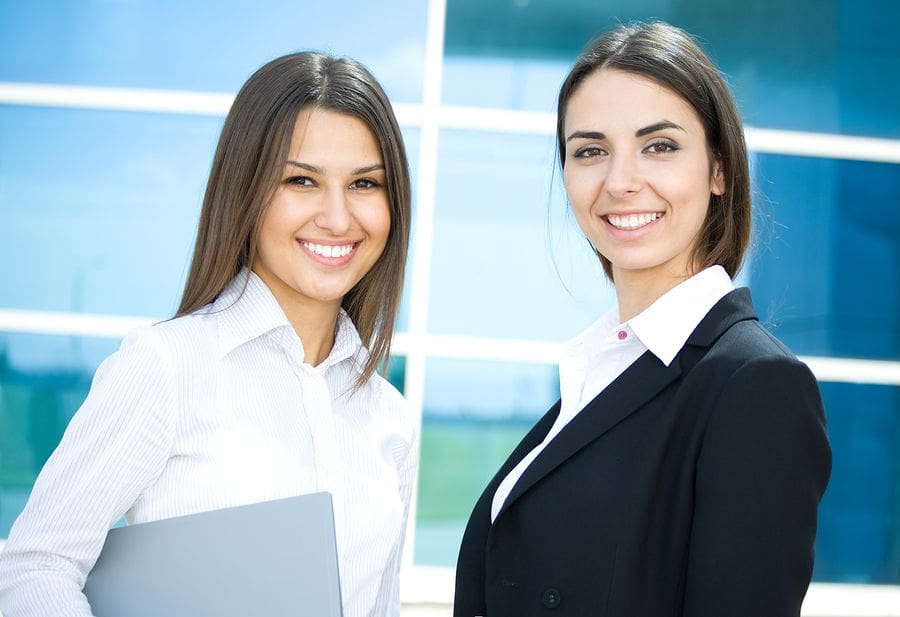 two young professional females lookig at camera