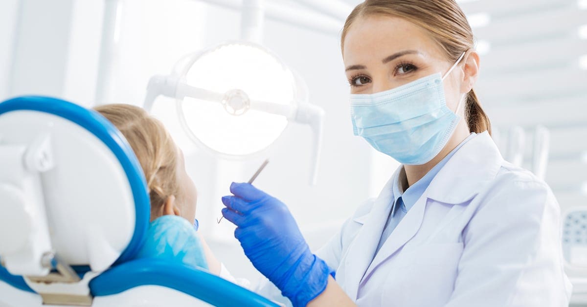 female dentist wearing mask