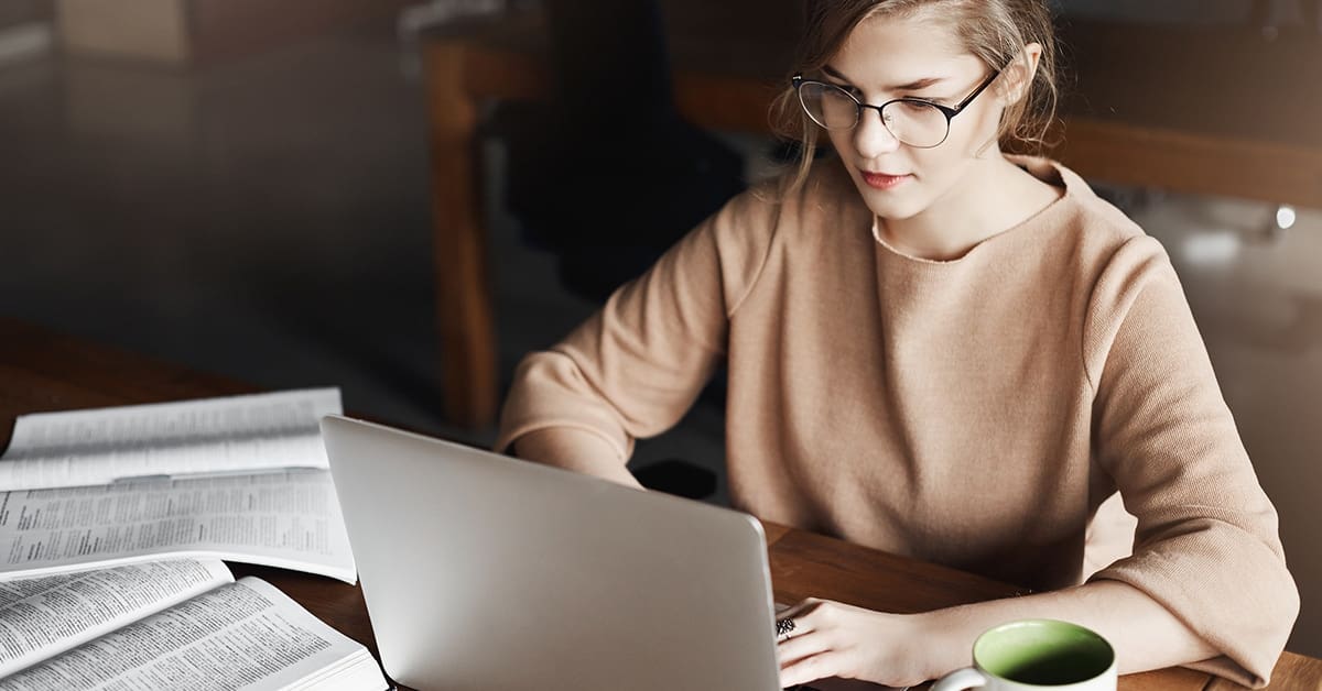 young woman studies on laptop