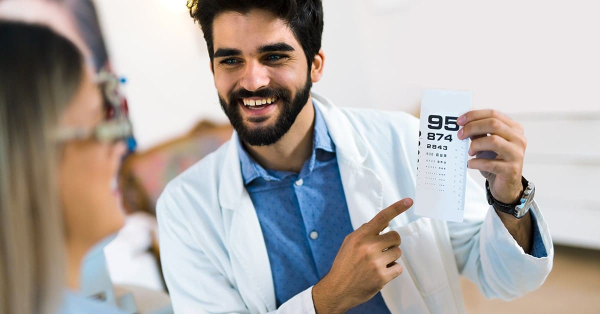 smiling male optometrist with patient