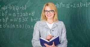 female teacher smiling blackboard