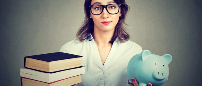 woman-compares-textbooks-piggybank
