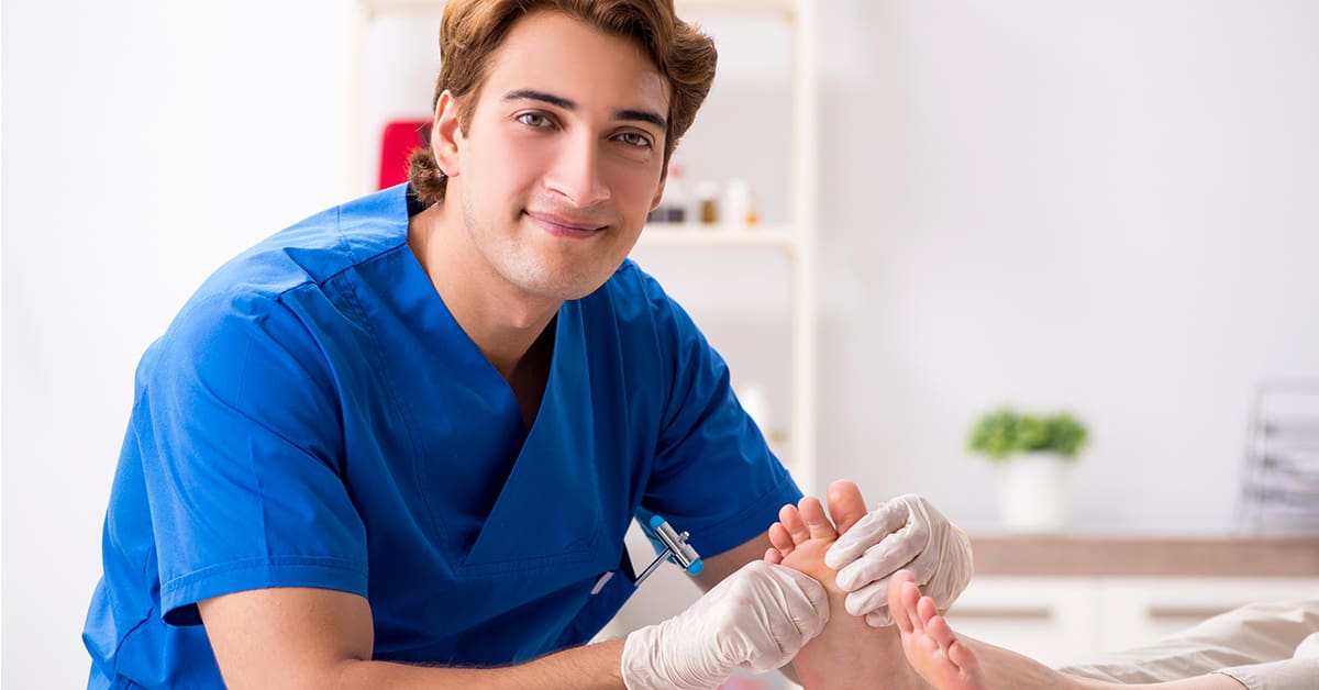 male podiatrist works on patient feet