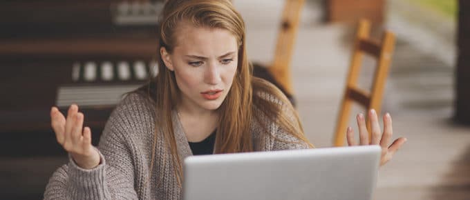 stressed young woman looking at laptop