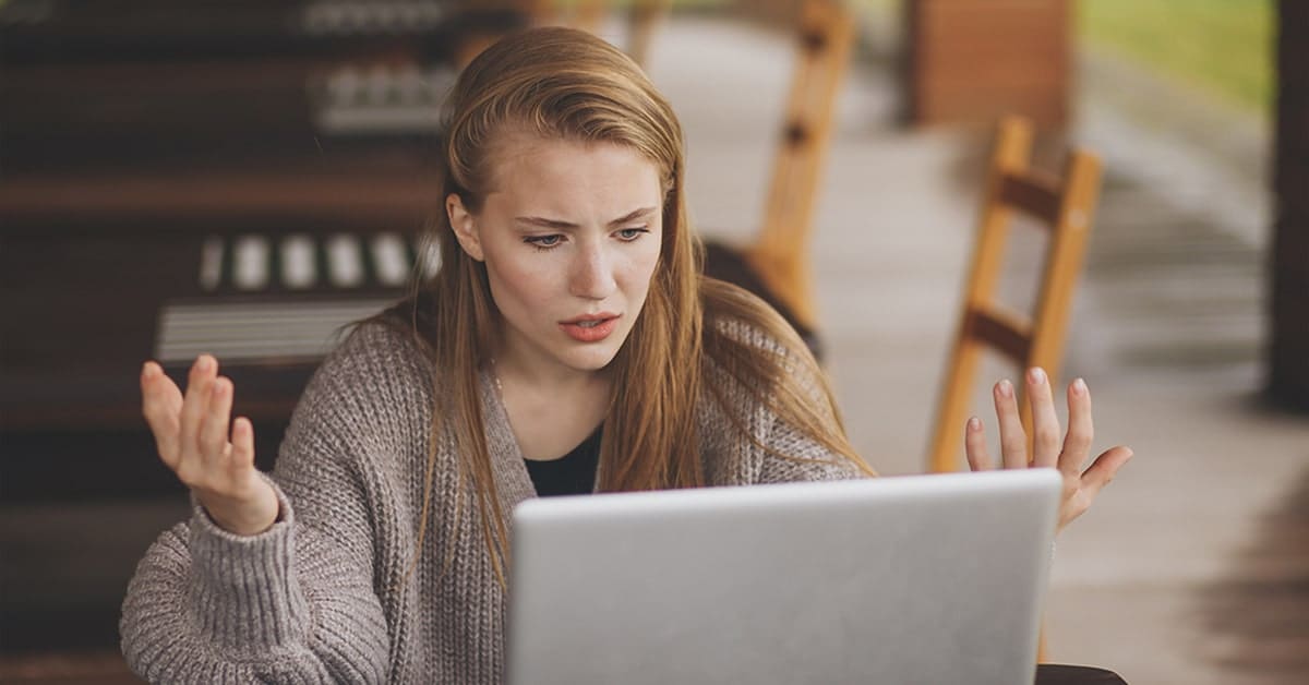 stressed young woman looking at laptop