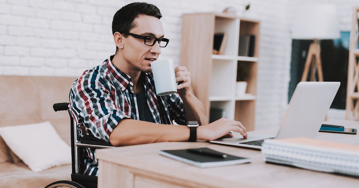 young-man-wheelchair-working-desk