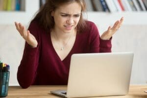annoyed-young-woman-gesturing-laptop