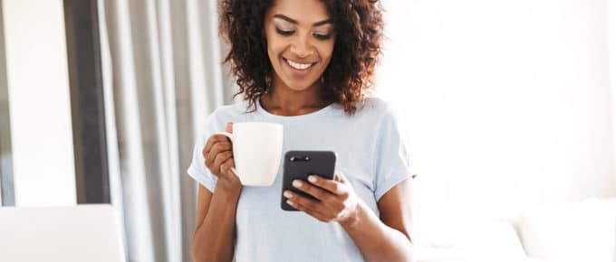 young-woman-smiling-mobile-phone-coffee