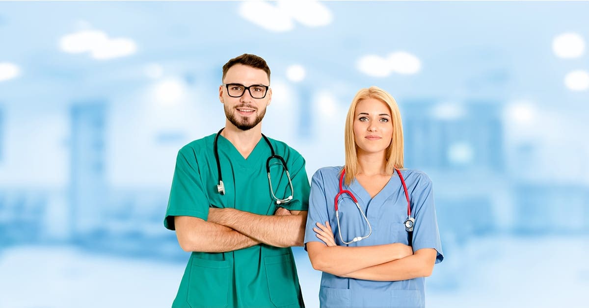 two-doctors-male-female-side-by-side-blue-hospital-background