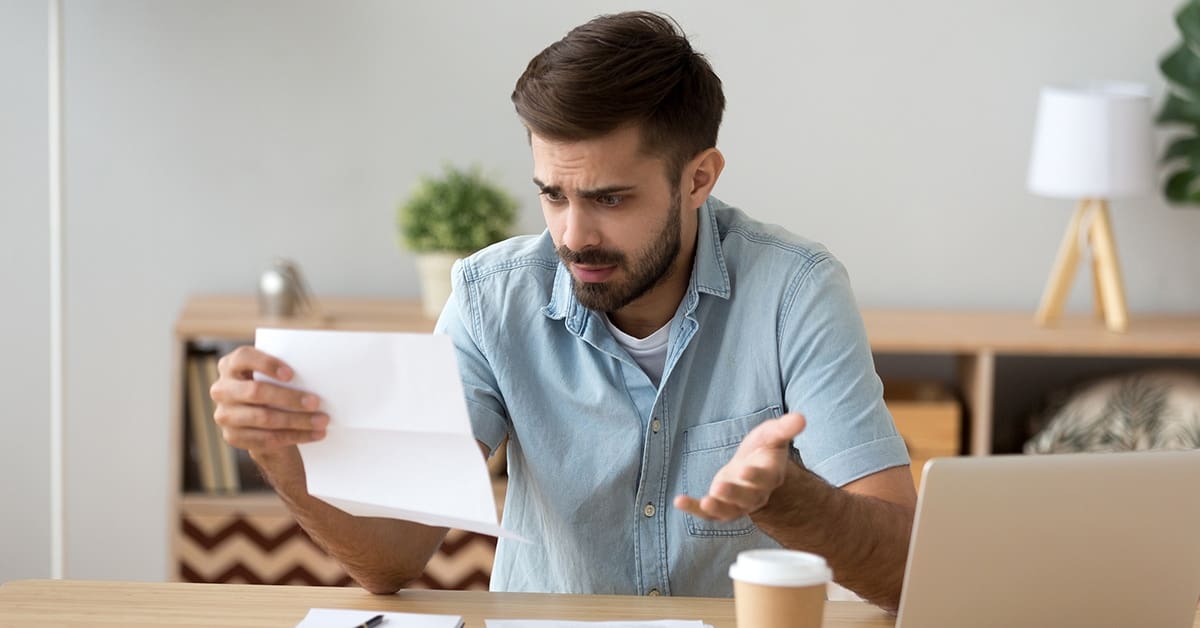 frustrated-man-reading-letter