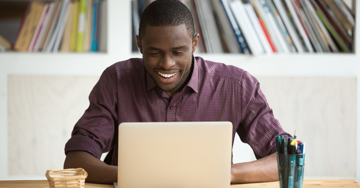 man-smiling-pleased-laptop