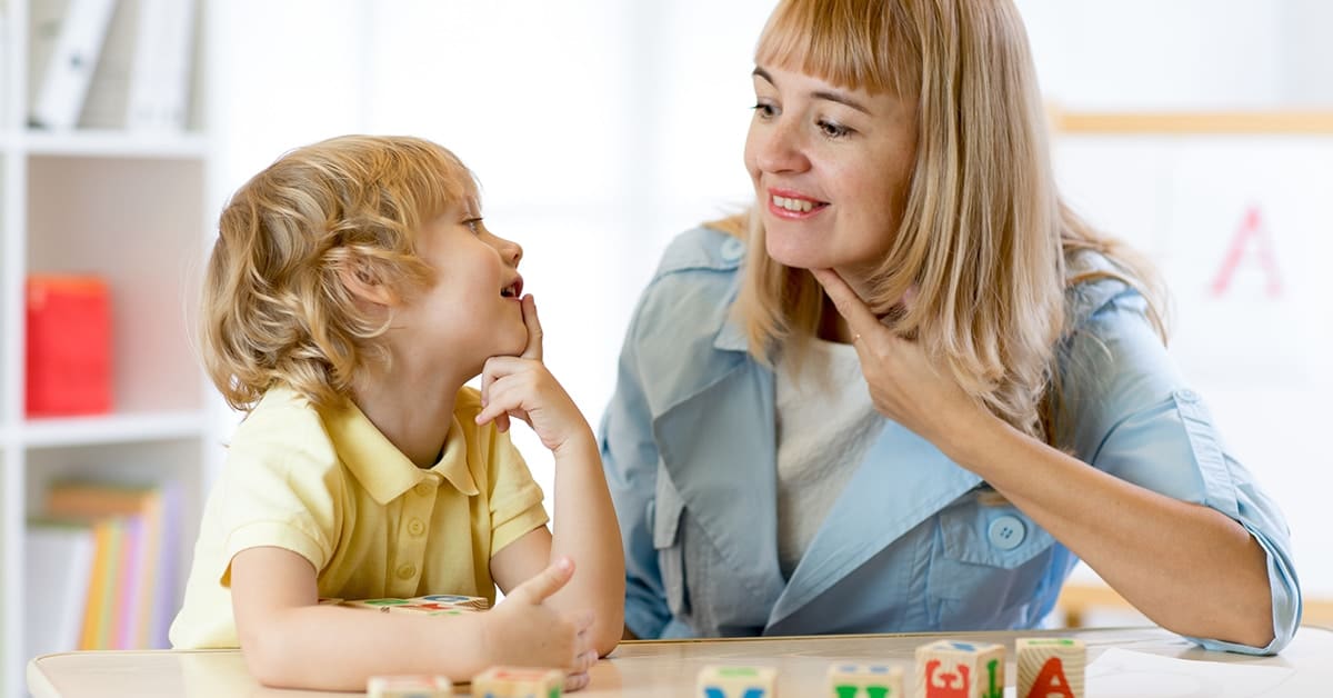 speech-language-pathologist-helping-little-boy-therapist-office