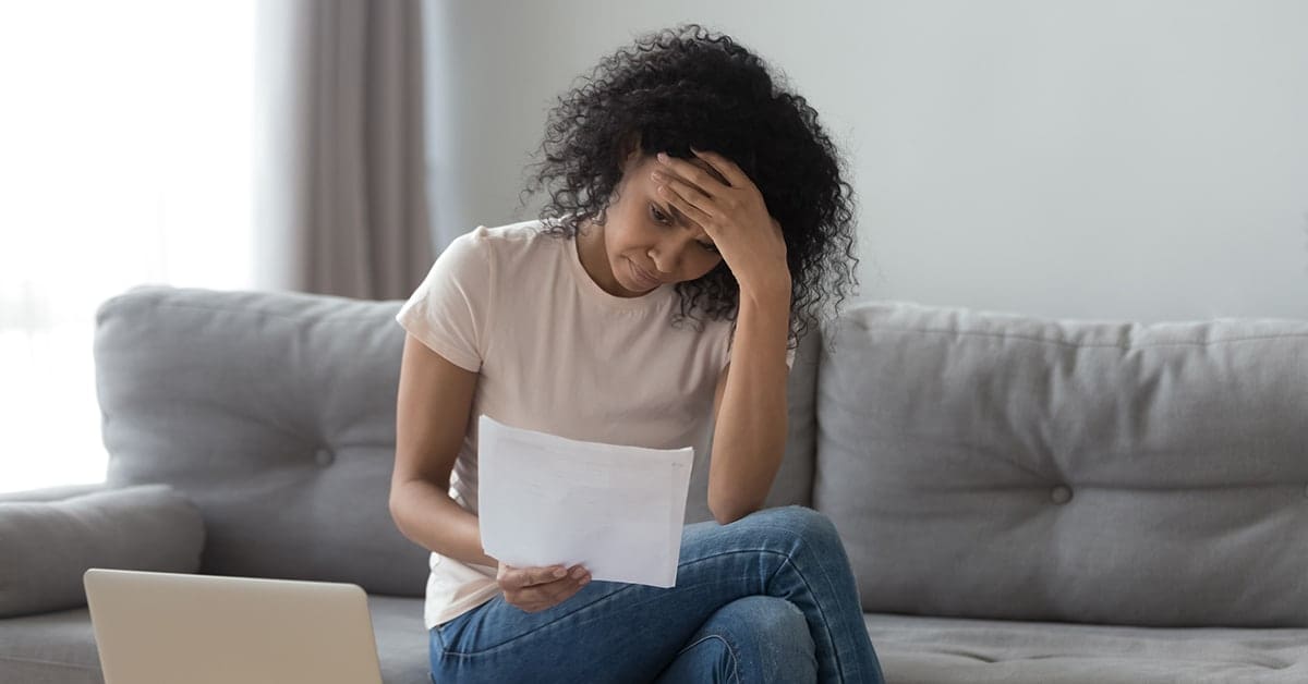 stressed-woman-reading-bills-bankruptcy