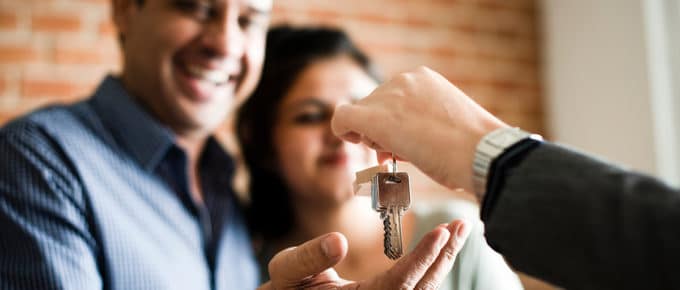 couple-taking-keys-from-realtor-new-home