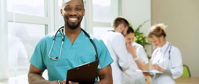 male-nurse-holding-clipboard-healthcare-background