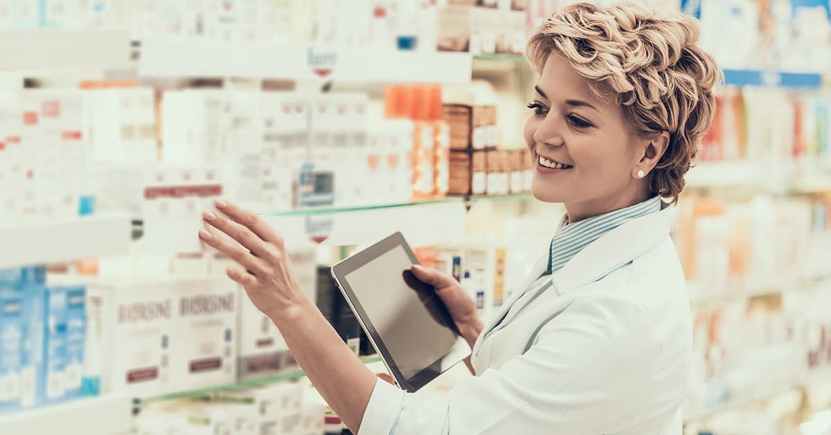 female-pharmacist-reaching-for-medicine-pharmacy-shelf