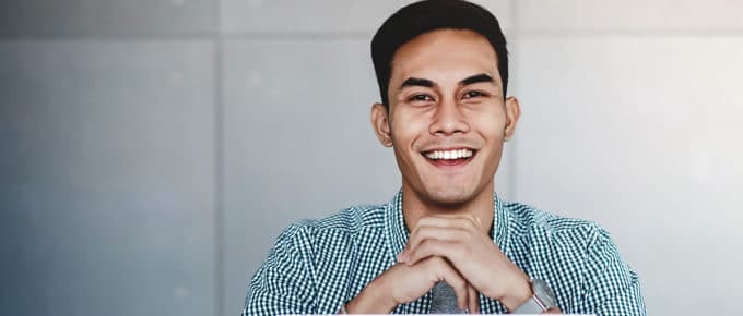 young-business-man-smiling-laptop