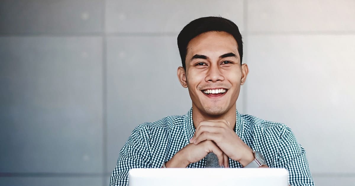 young-business-man-smiling-laptop