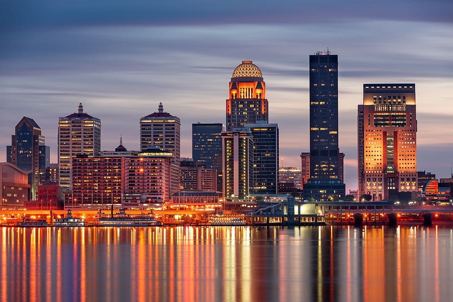 Louisville, Kentucky, USA skyline on the Ohio River at night.