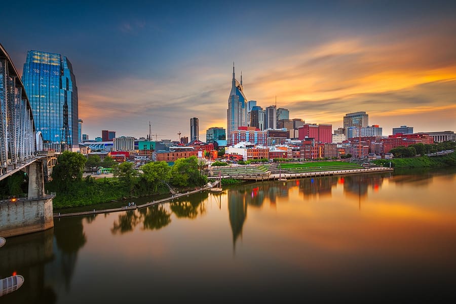 Nashville, Tennessee, USA downtown city skyline at dusk on the Cumberland River.