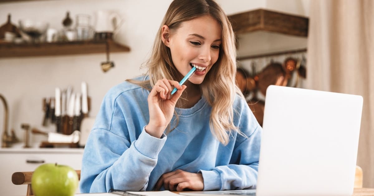 Woman in Sweatshirt on Laptop at Home