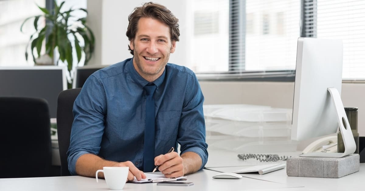 Man Taking Notes by Laptop