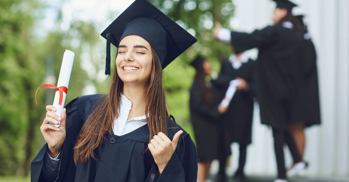 Female Graduate Giving Thumbs Up