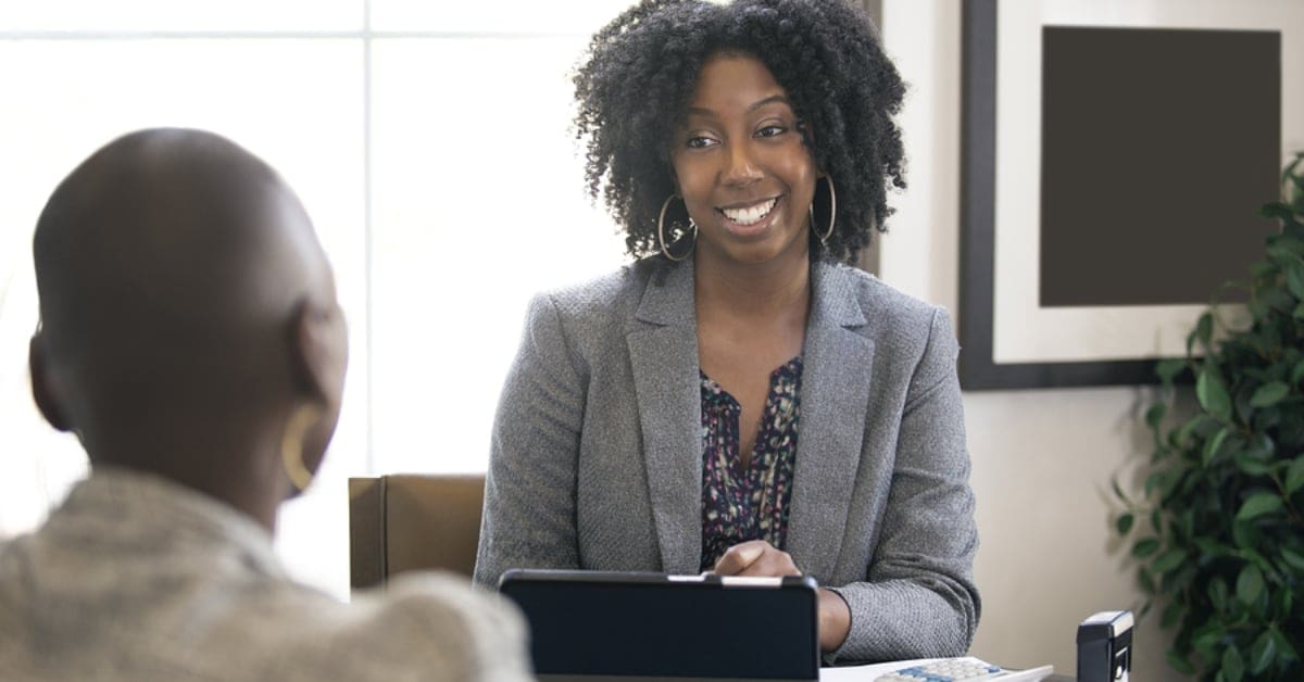 African American Professional Woman Smiling at Peer