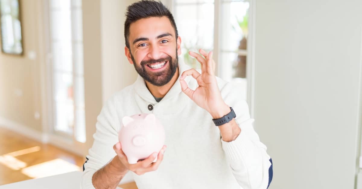 Man Doing A-Ok Sign Holding Piggy Bank