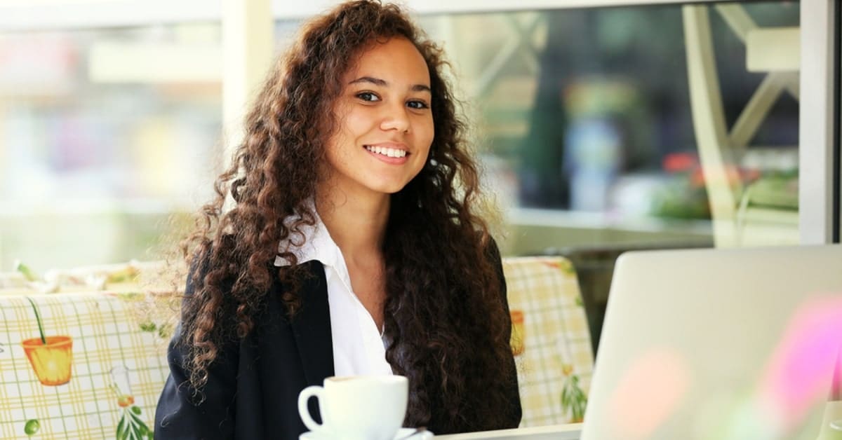 Woman Drinking Tea and on Laptop