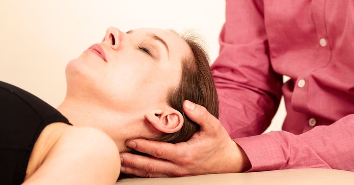 Naturopathic Doctor Holding Patient's Head