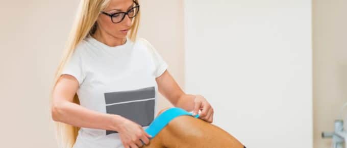 Physical Therapist Using Band on Patient's knee