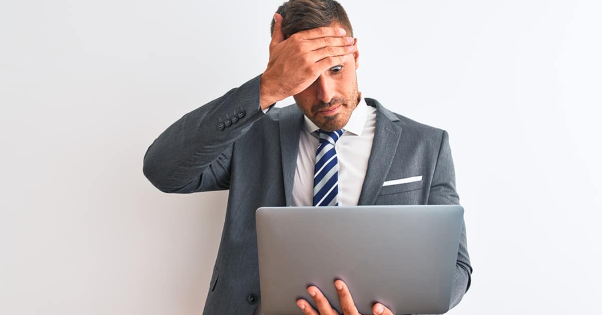 Stunned Man Looking at Laptop