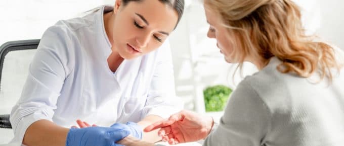 Dermatologist Examining Patient's Wrist