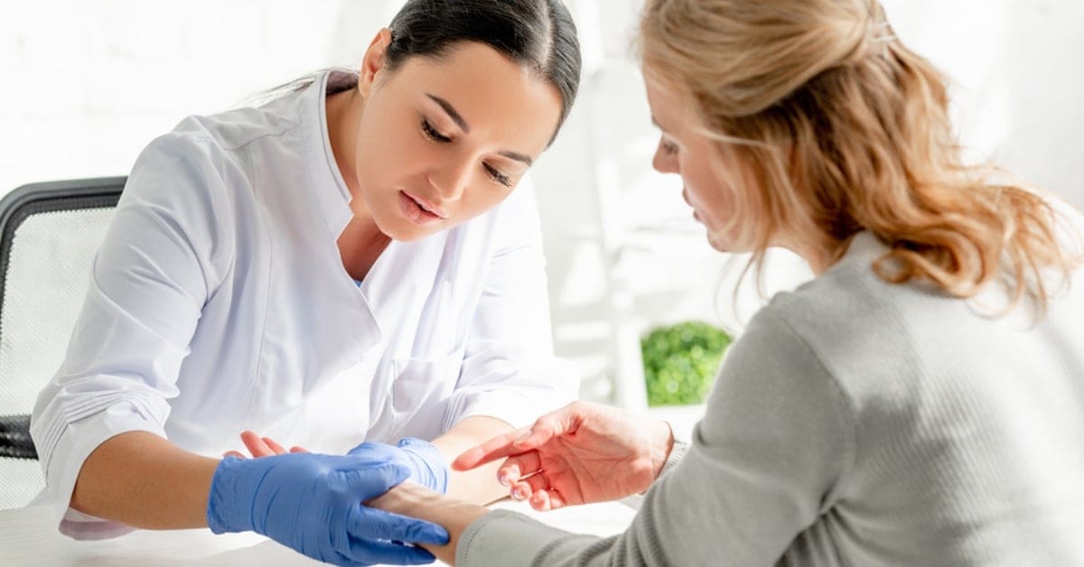 Dermatologist Examining Patient's Wrist