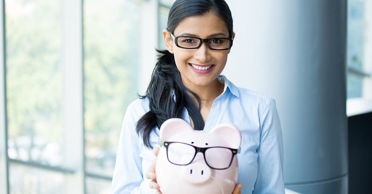 Woman Smiling Holding Piggy Bank
