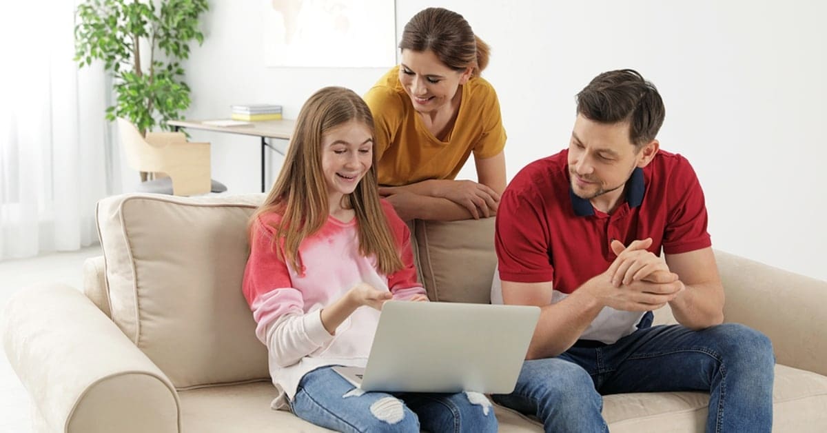 Family of Three Looking at Laptop