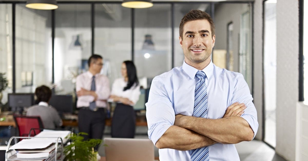 Man in Tie Smiling for Camera in Office