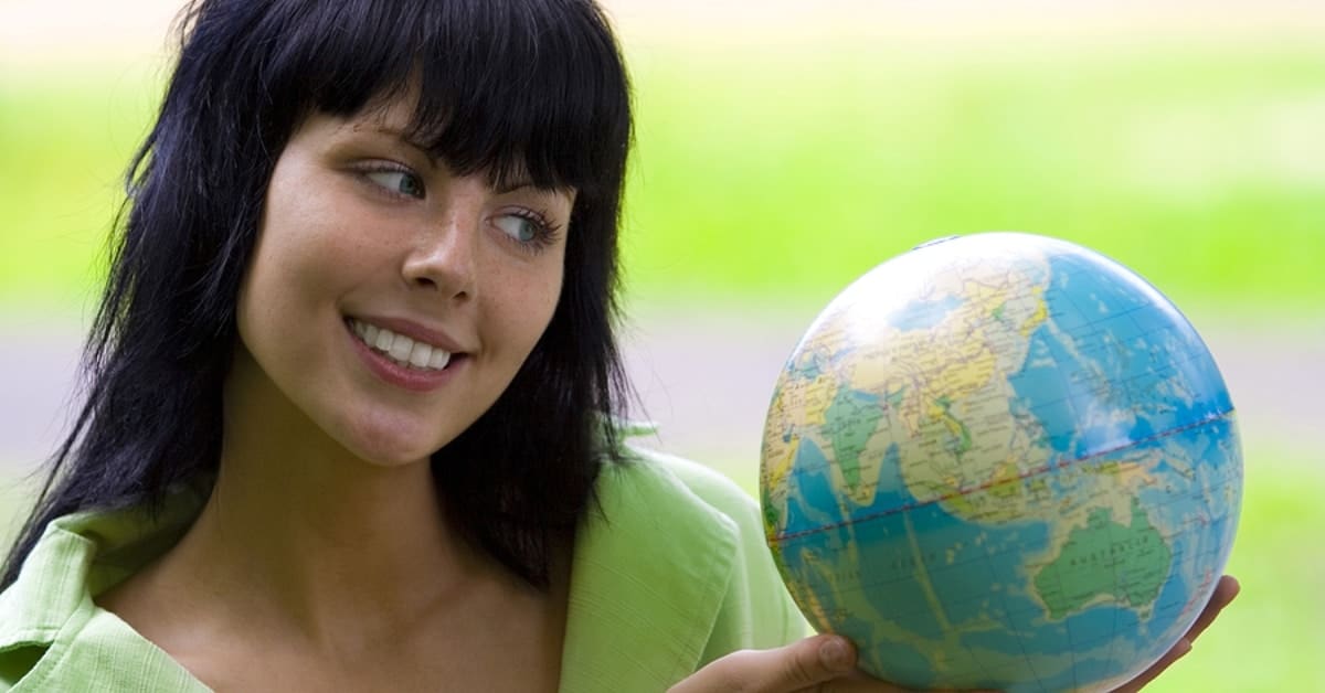 Woman Holding Globe Smiling