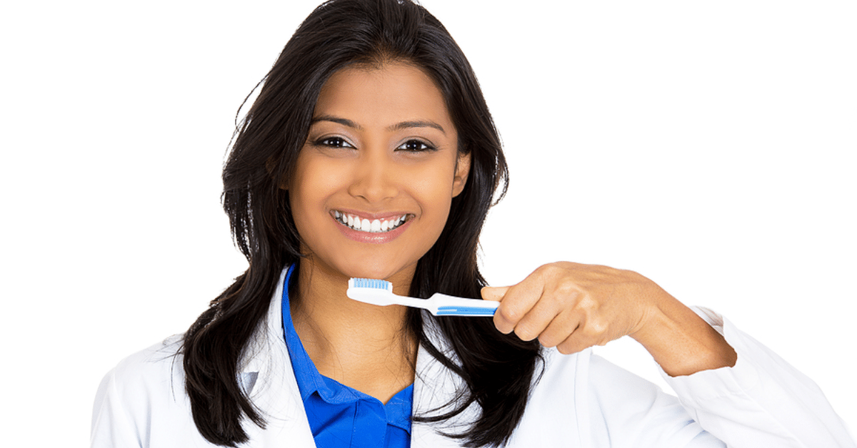 Female Dentist Posing Smiling with Toothbrush