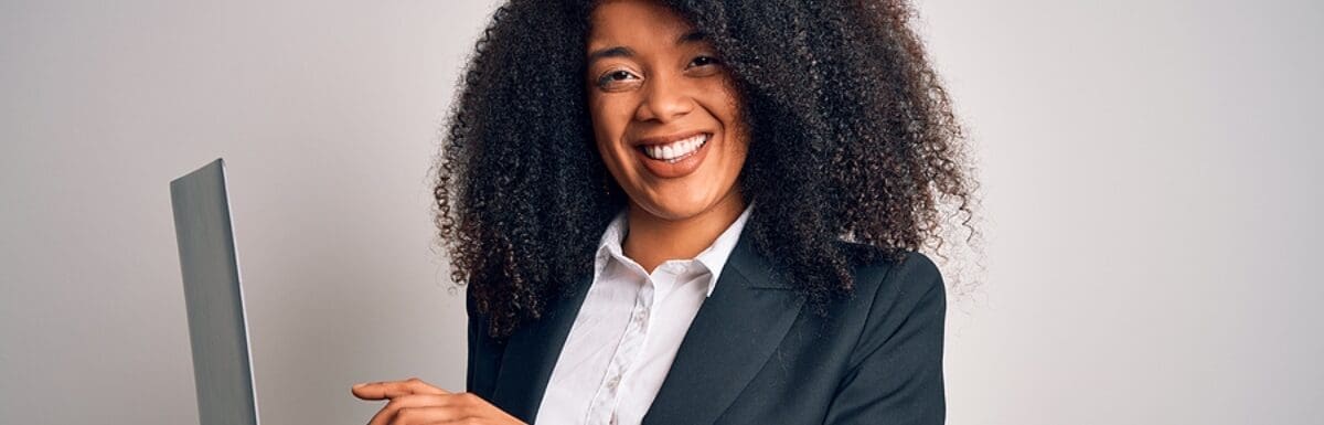 African American Female Professional Smiling Holding Laptop